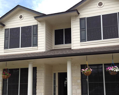 solar screens on a white house in austin installed by Dan White's Screens & Things